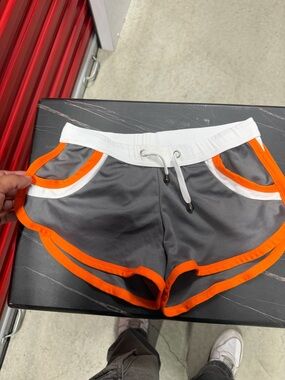 Gray Athletic Shorts with Orange Trim and White Waistband